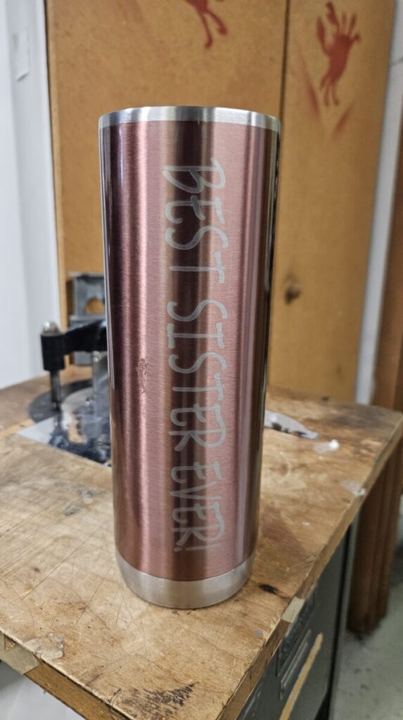 A pink and silver metal can with white text on it.