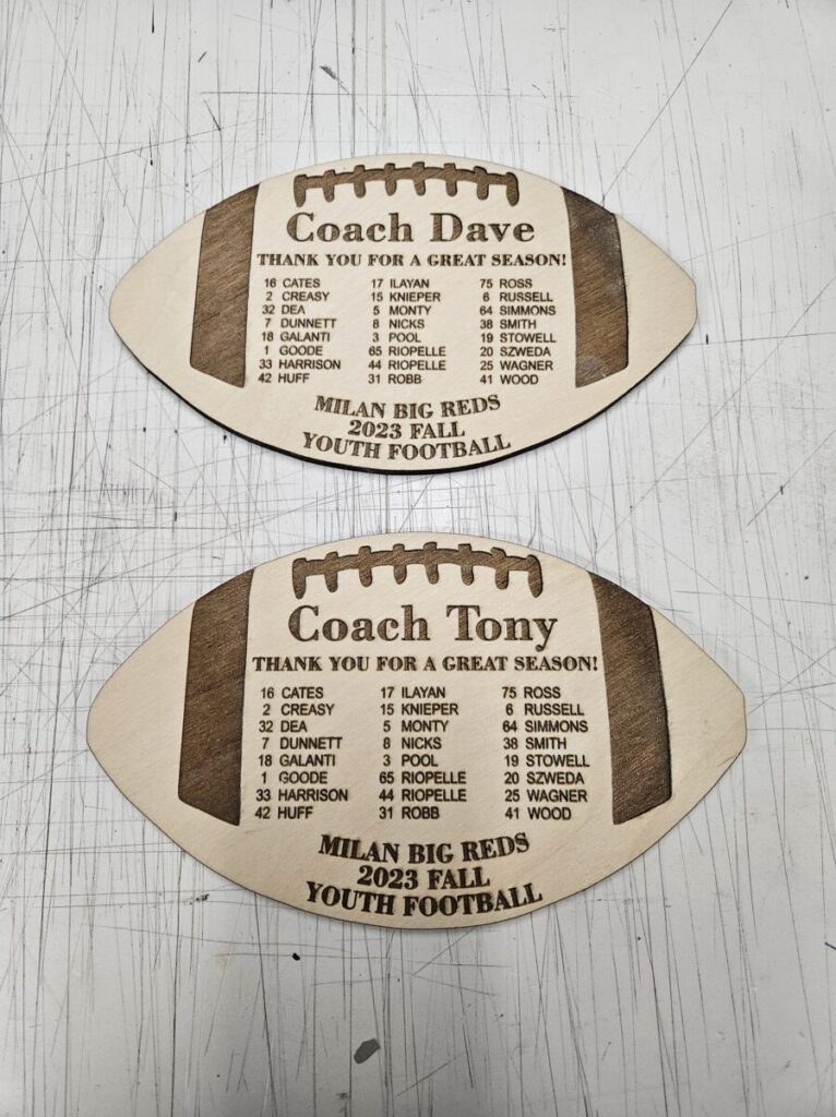 A football shaped plaque on a white surface.